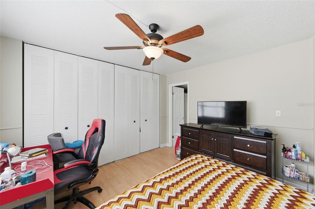 7701 Starkey Road, Unit 237 Seminole, FL 33777 - Photo 20 of 32 a bedroom with a bed and a flat screen tv