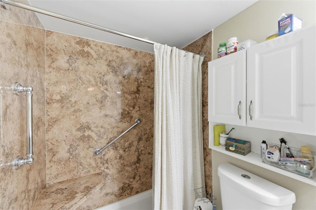 7701 Starkey Road, Unit 237 Seminole, FL 33777 - Photo 22 of 32 a bathroom with a shower curtain and a sink