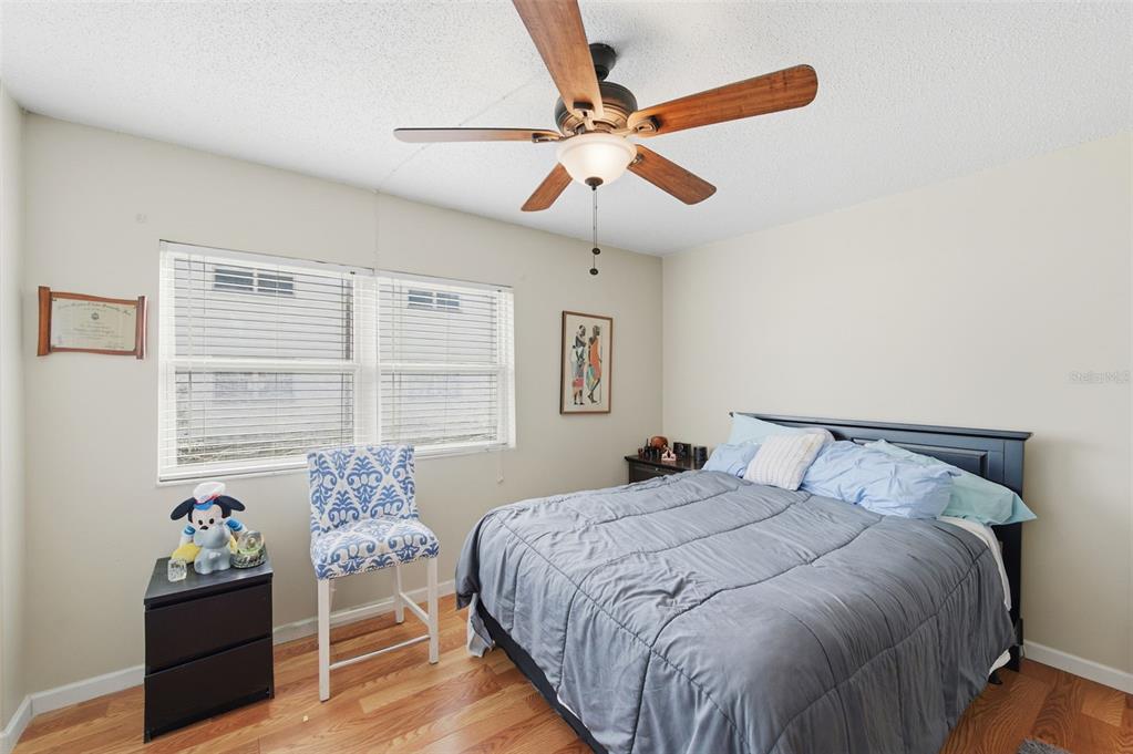 7701 Starkey Road, Unit 237 Seminole, FL 33777 - Photo 23 of 32 a bedroom with a bed and a chandelier