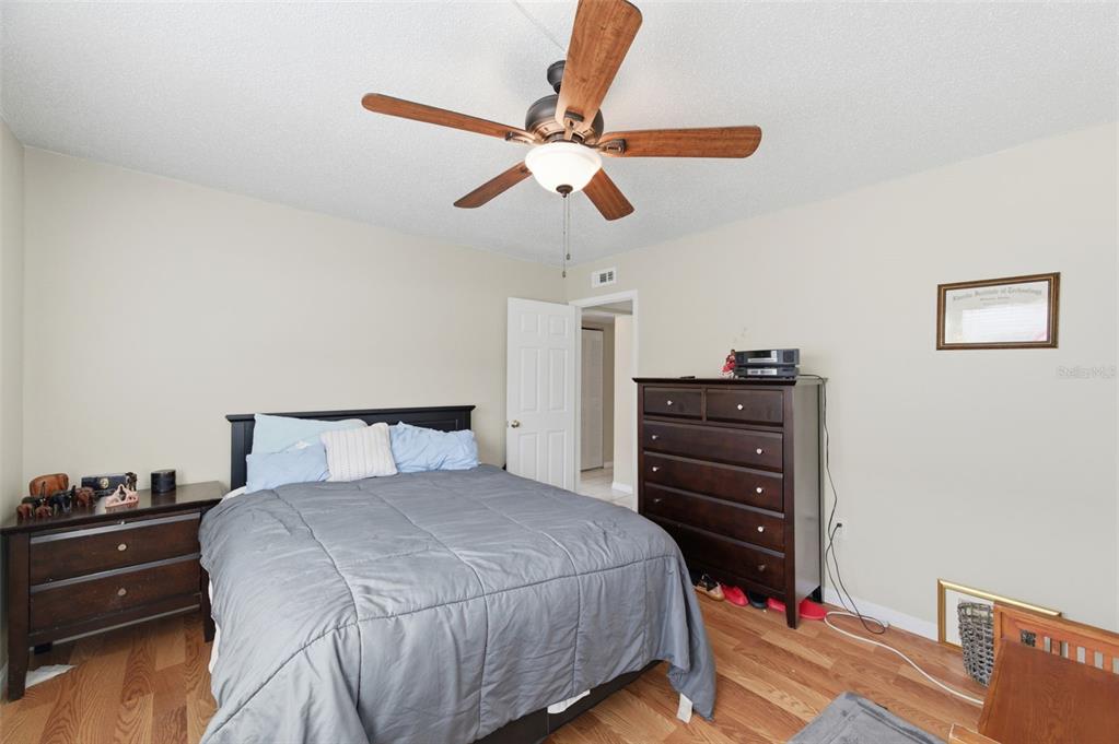 7701 Starkey Road, Unit 237 Seminole, FL 33777 - Photo 24 of 32 a bedroom with a bed and a chandelier