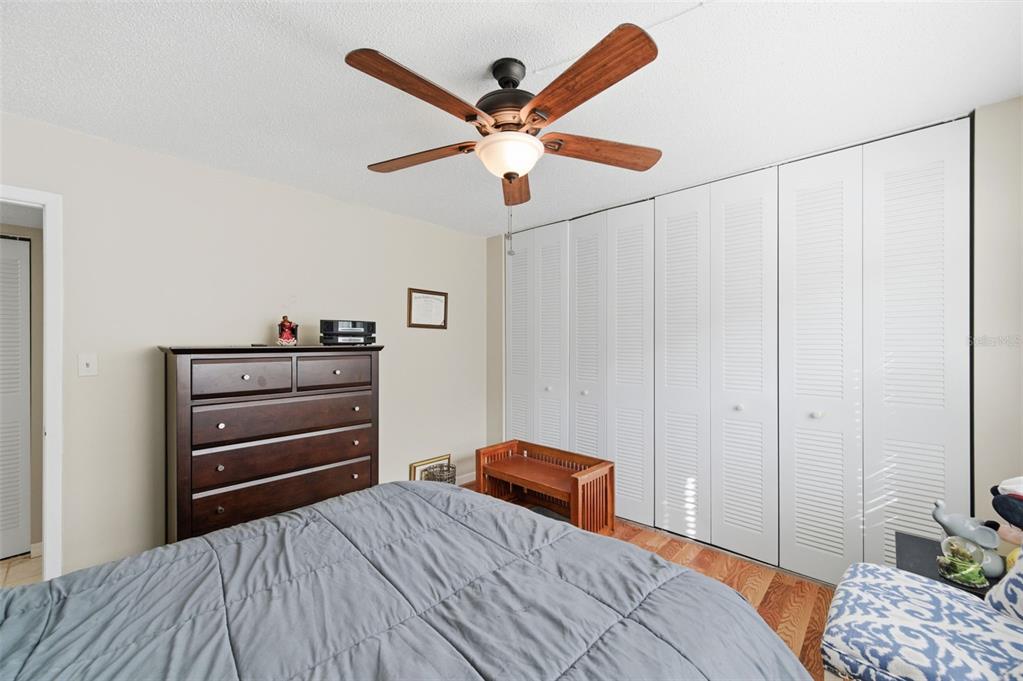 7701 Starkey Road, Unit 237 Seminole, FL 33777 - Photo 25 of 32 a bedroom with a bed and a chandelier