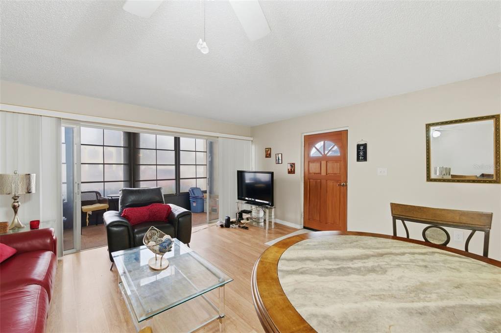 7701 Starkey Road, Unit 237 Seminole, FL 33777 - Photo 5 of 32 a living room with furniture a flat screen tv and a large window