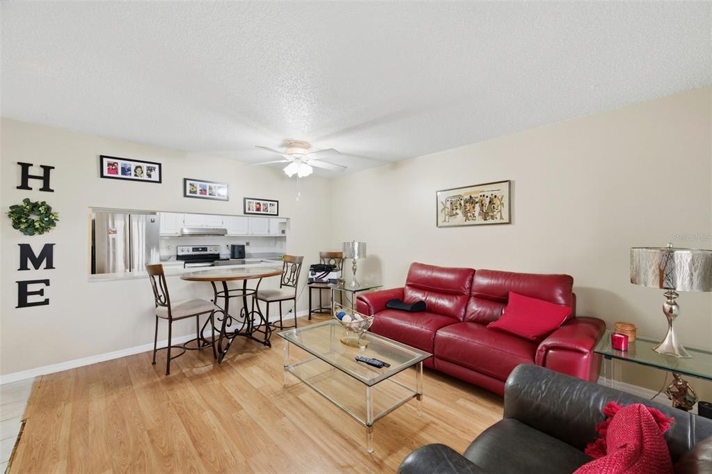 7701 Starkey Road, Unit 237 Seminole, FL 33777 - Photo 7 of 32 a living room with furniture and a wooden floor