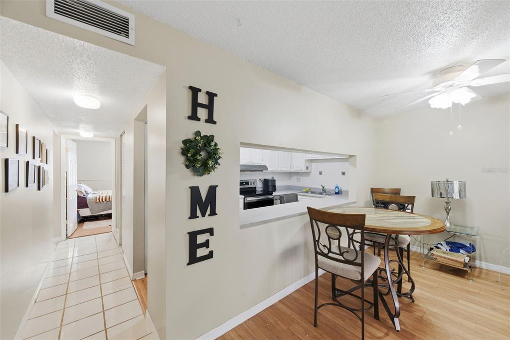7701 Starkey Road, Unit 237 Seminole, FL 33777 - Photo 8 of 32 a view of a dining room with furniture and wooden floor