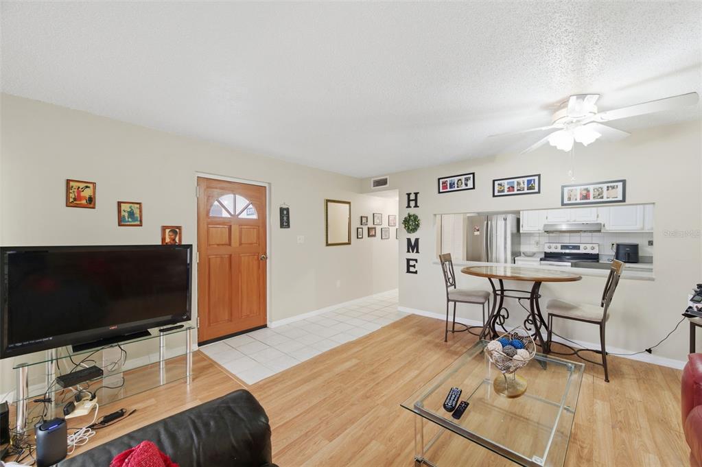 7701 Starkey Road, Unit 237 Seminole, FL 33777 - Photo 9 of 32 a living room with furniture and a flat screen tv