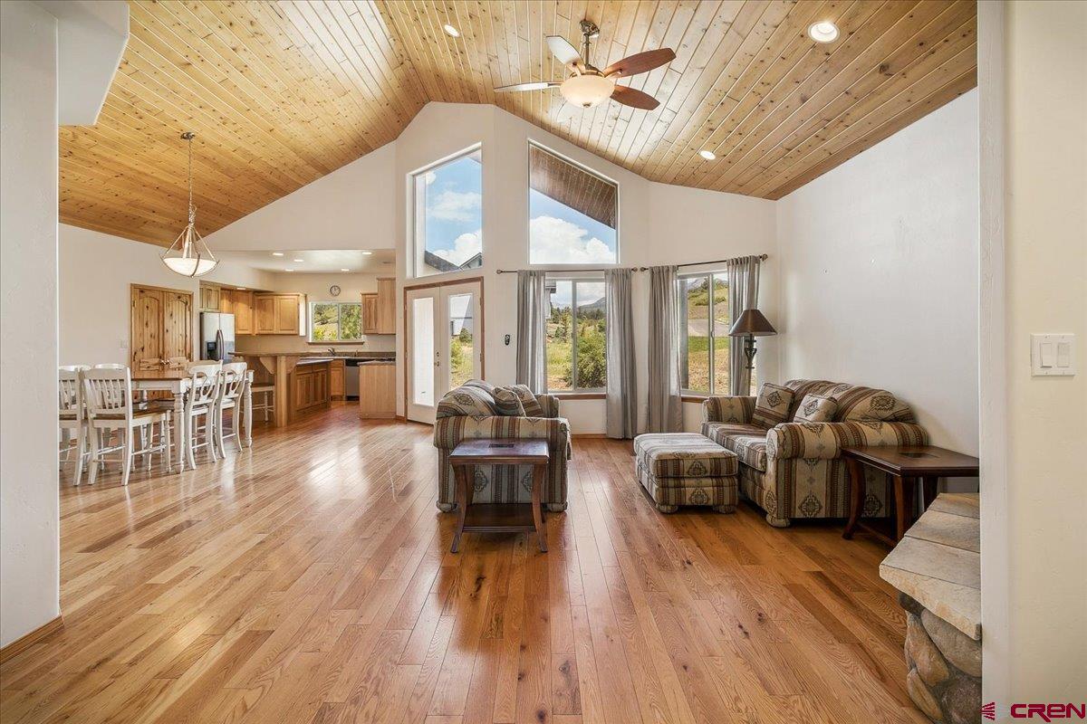 196 Dylan Drive Pagosa Springs, CO 81147 - Photo 11 of 44 a living room with furniture a wooden floor and a chandelier