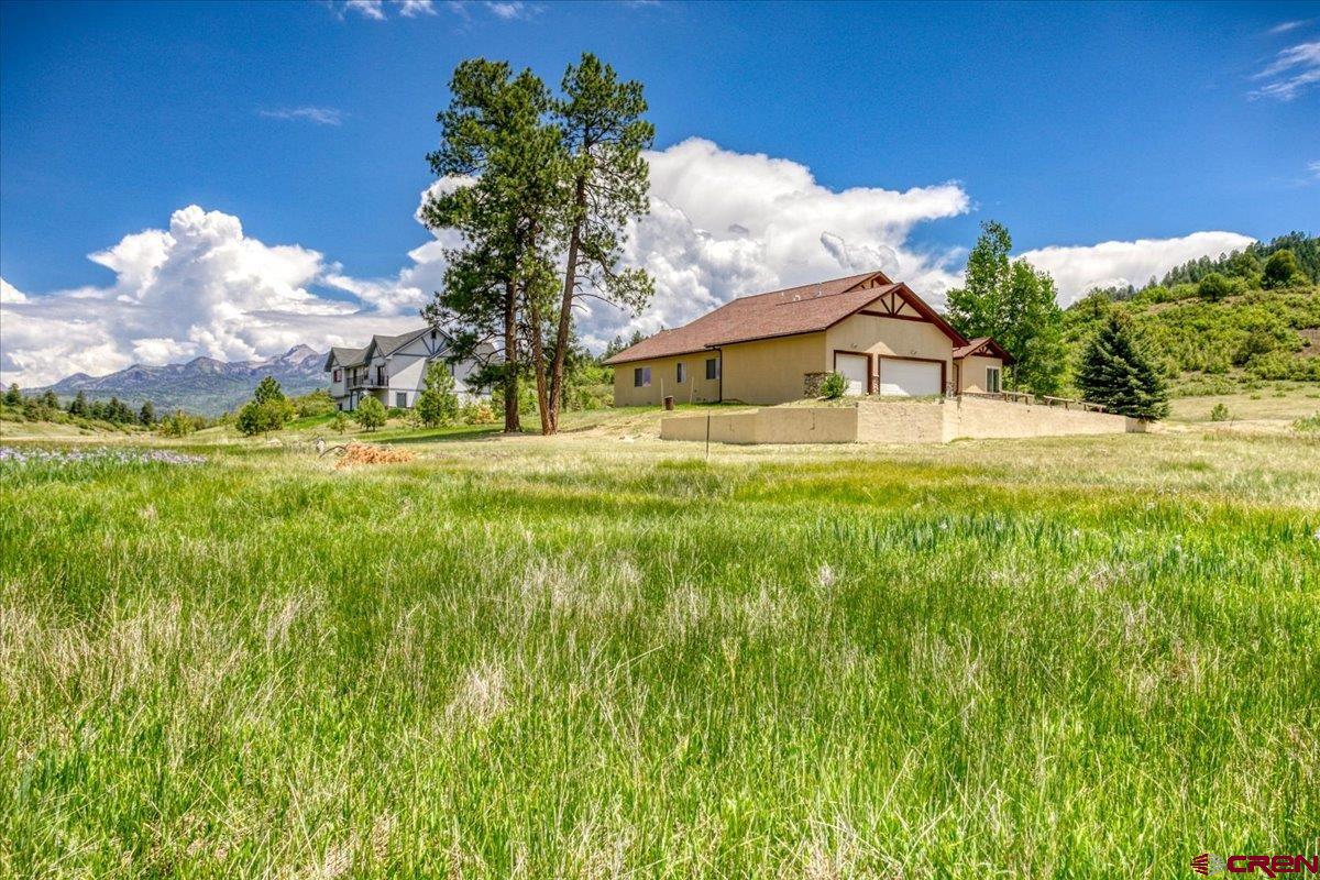 196 Dylan Drive Pagosa Springs, CO 81147 - Photo 2 of 44 a house view with swimming pool in front of it