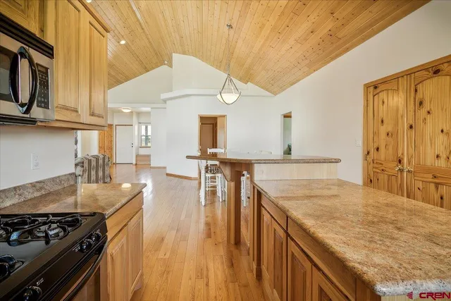 a kitchen with stainless steel appliances granite countertop a stove and a sink
