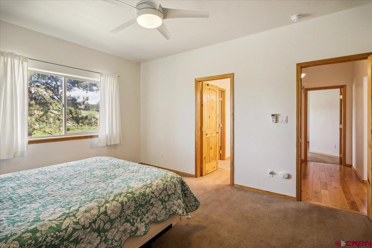 196 Dylan Drive Pagosa Springs, CO 81147 - Photo 30 of 44 a bedroom with a bed and a painting on the wall