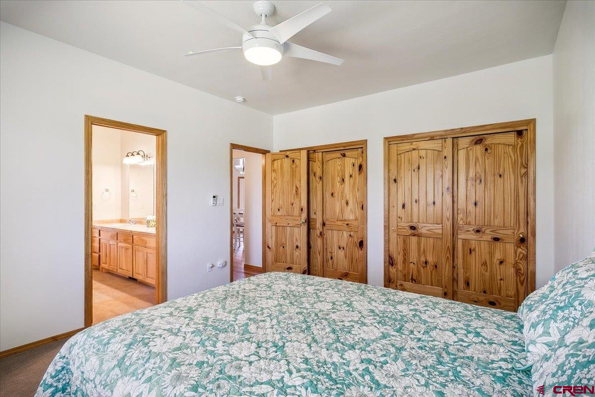 196 Dylan Drive Pagosa Springs, CO 81147 - Photo 31 of 44 a bedroom with a bed and a chandelier