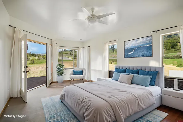 a spacious bedroom with a large bed and a large window