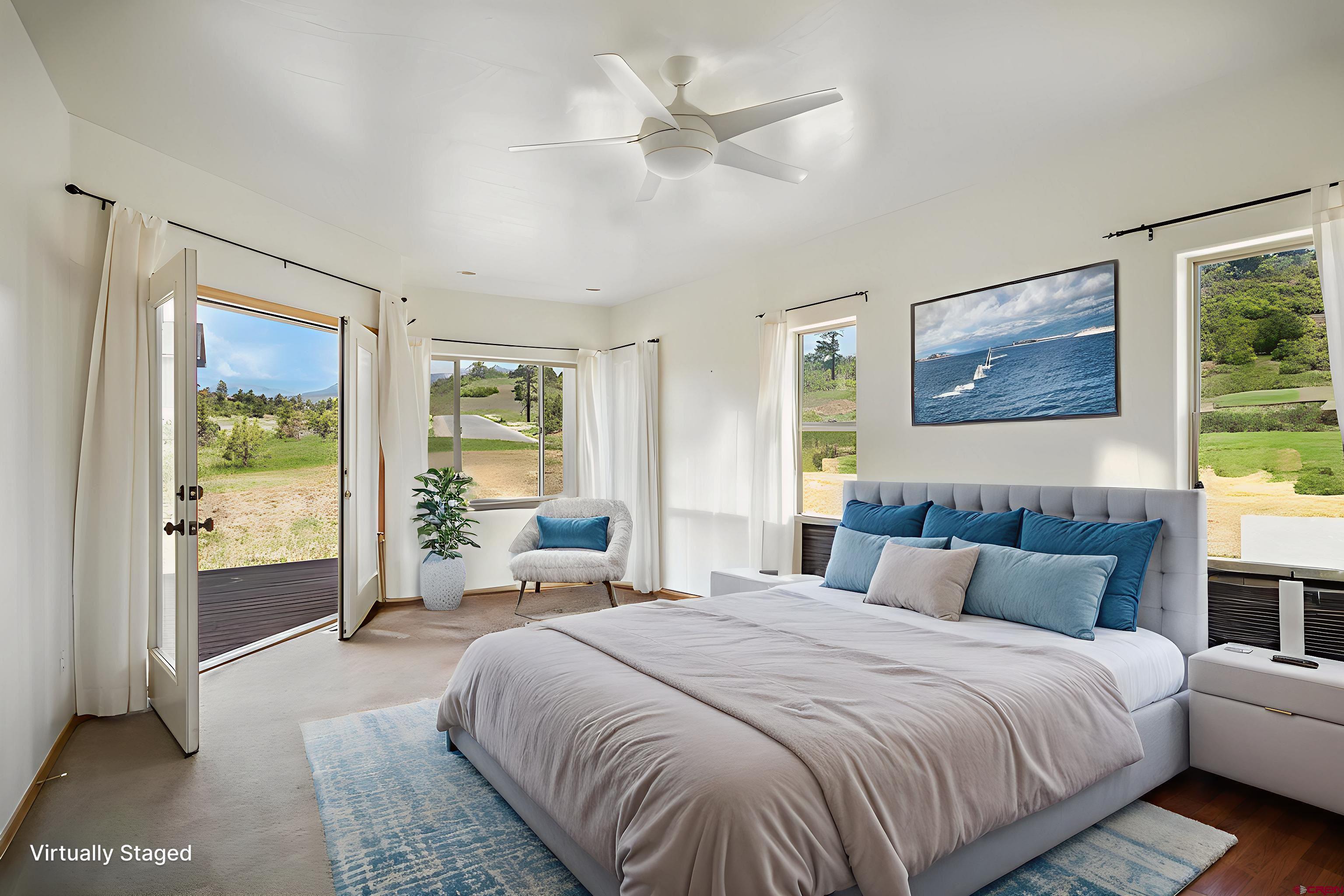 196 Dylan Drive Pagosa Springs, CO 81147 - Photo 33 of 44 a spacious bedroom with a large bed and a large window