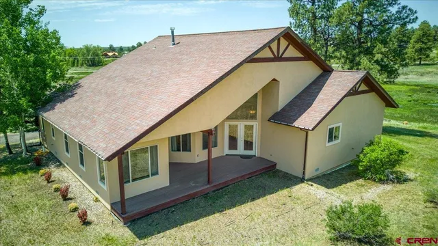 an aerial view of a house with a yard