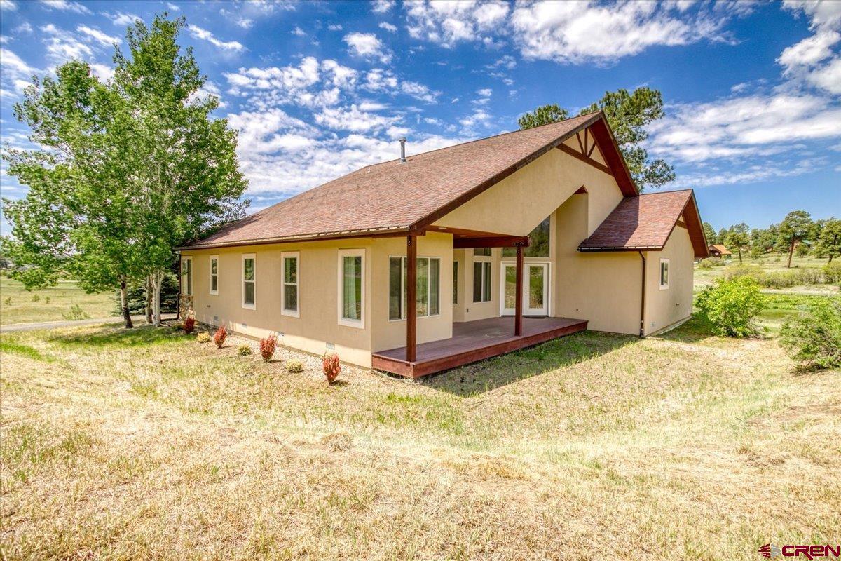 196 Dylan Drive Pagosa Springs, CO 81147 - Photo 4 of 44 a view of a house with a yard