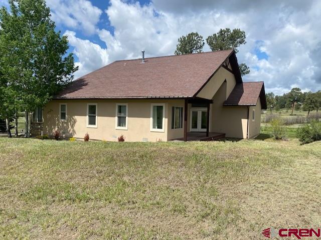 196 Dylan Drive Pagosa Springs, CO 81147 - Photo 42 of 44 a front view of a house with a garden