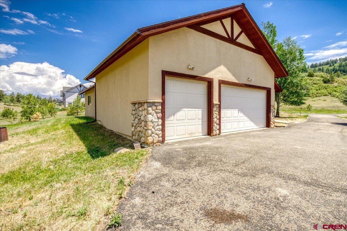 196 Dylan Drive Pagosa Springs, CO 81147 - Photo 8 of 44 a view of a house with backyard and trees