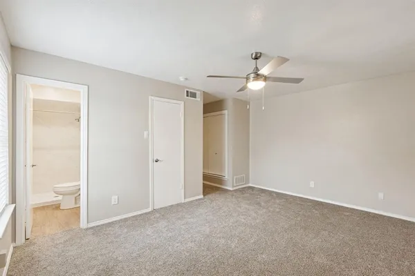 a view of an empty room and a bathroom