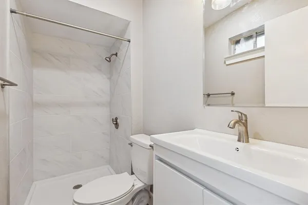 a bathroom with a sink toilet and shower