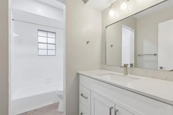 a bathroom with a bathtub and a sink