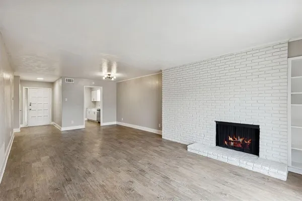 a view of an empty room with a fireplace