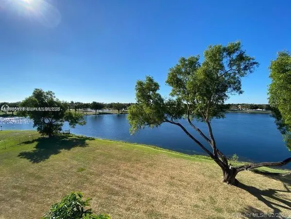 a view of a lake in between two chairs