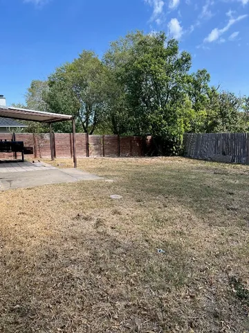 a backyard of a house with lots of green space