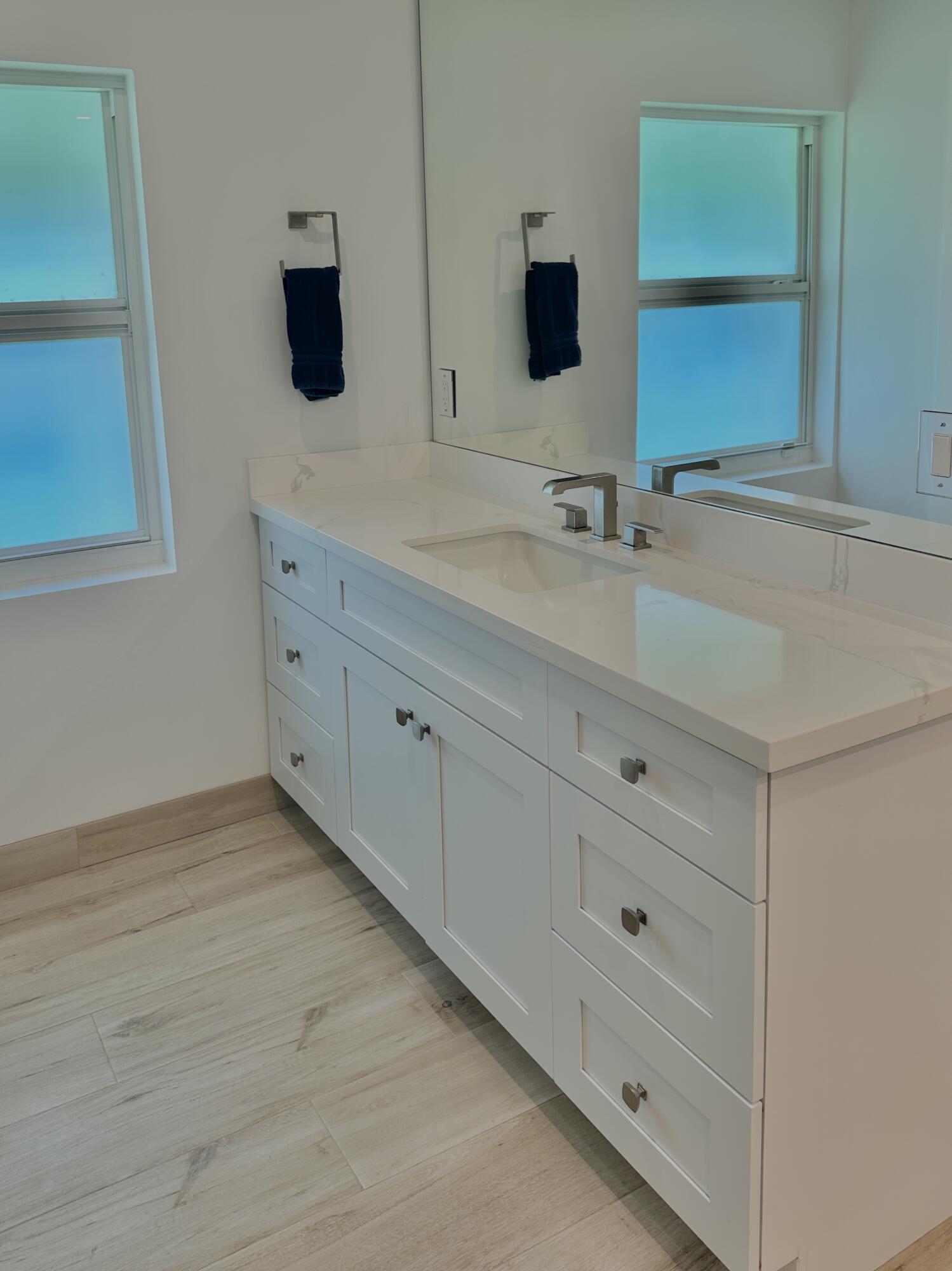 936 Southwest 38th Court Boynton Beach, FL 33435 - Photo 11 of 18 a bathroom with a sink and a mirror