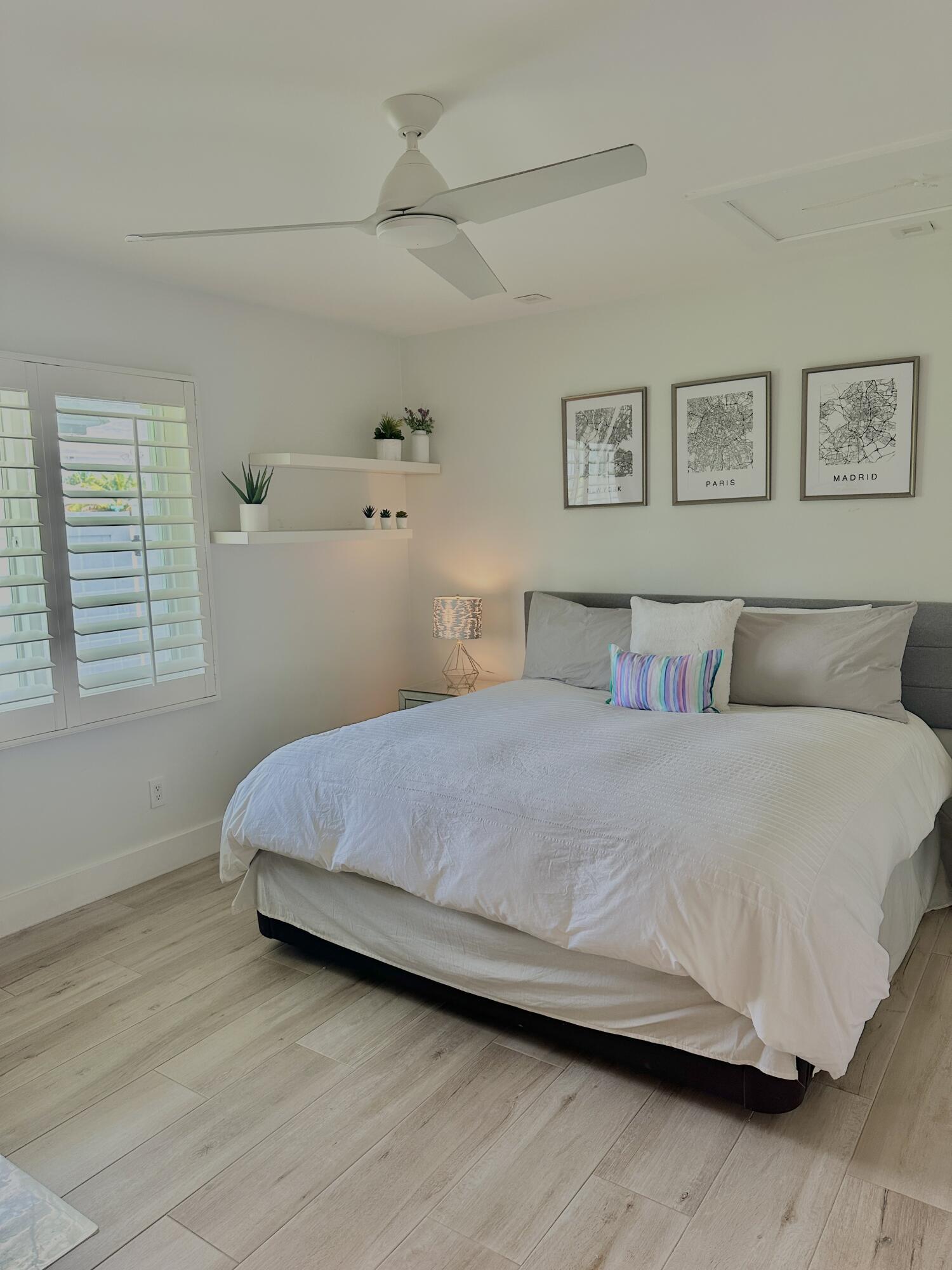 936 Southwest 38th Court Boynton Beach, FL 33435 - Photo 12 of 18 a bedroom with a bed and wall painting