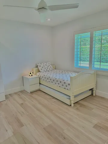 a view of a bed room with a bed and a window