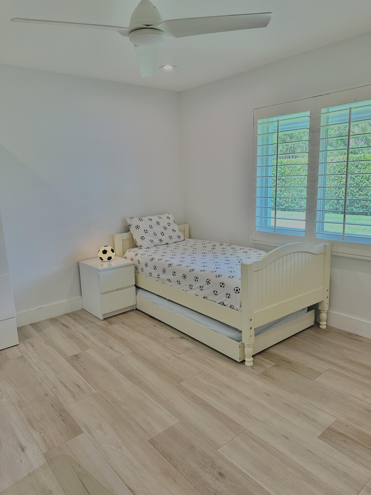 936 Southwest 38th Court Boynton Beach, FL 33435 - Photo 15 of 18 a view of a bed room with a bed and a window