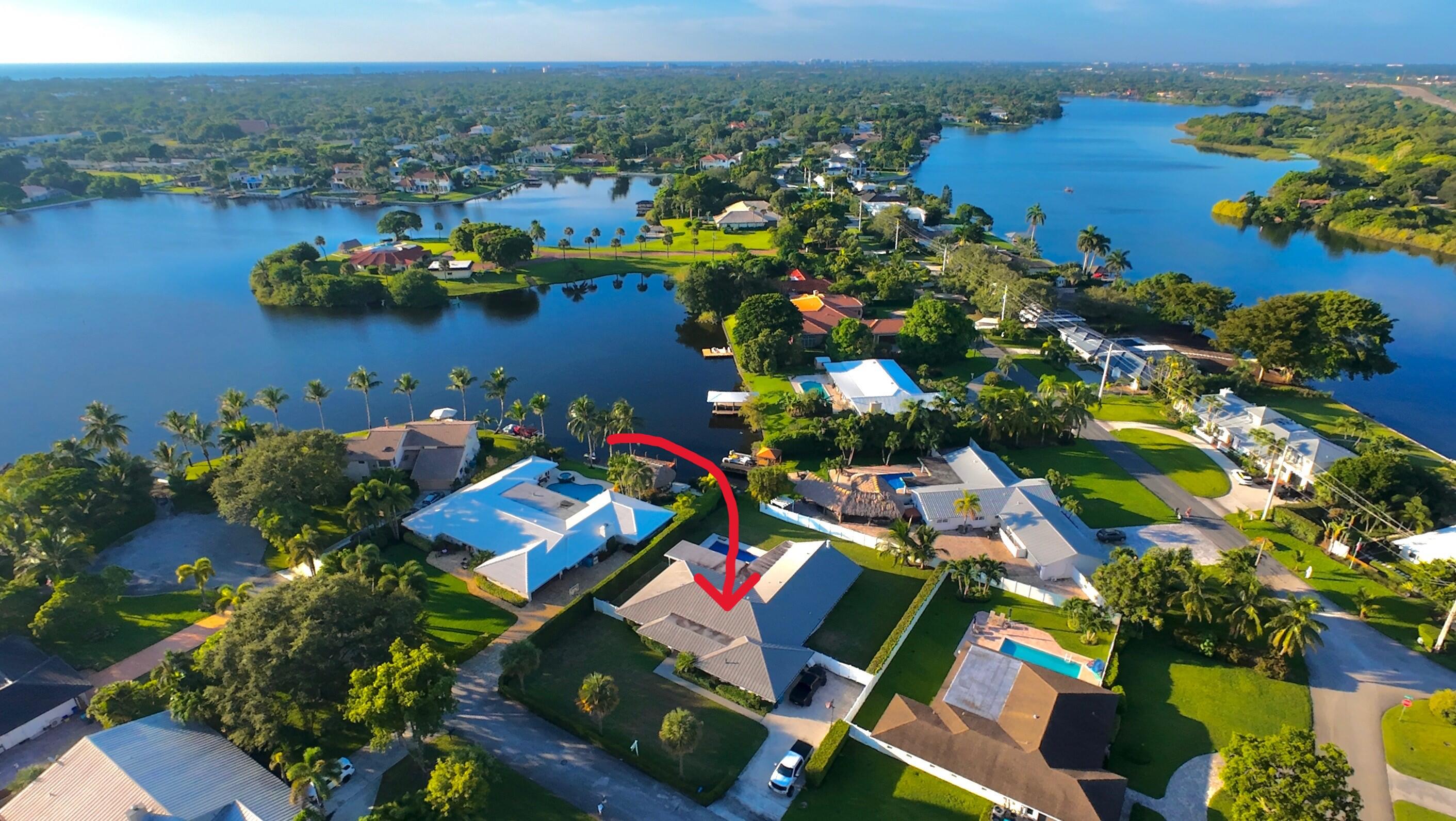 936 Southwest 38th Court Boynton Beach, FL 33435 - Photo 2 of 18 an aerial view of a houses with a lake
