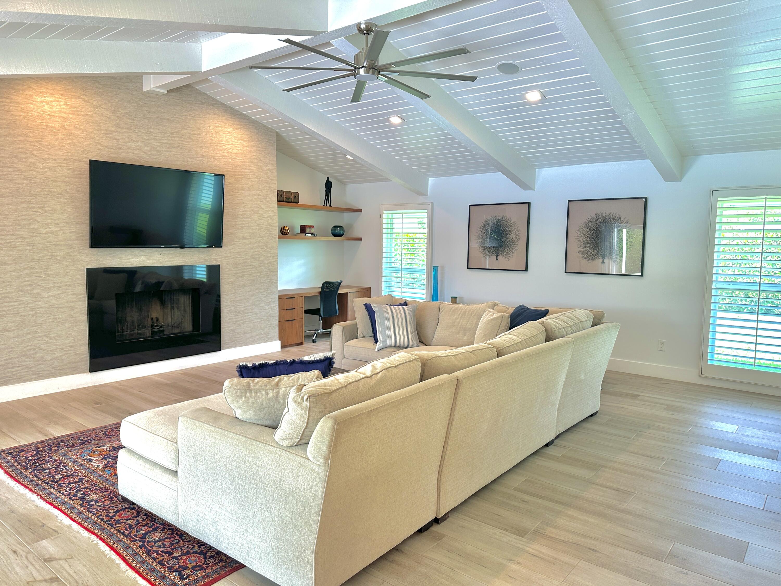 936 Southwest 38th Court Boynton Beach, FL 33435 - Photo 5 of 18 a living room with furniture a flat screen tv and a fireplace