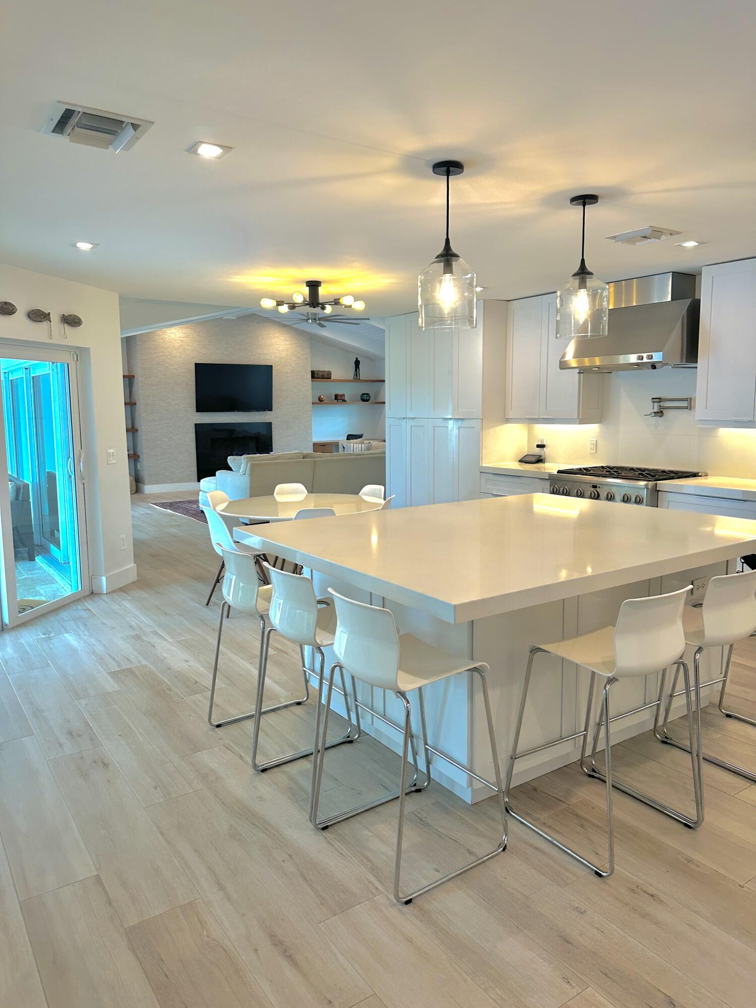 936 Southwest 38th Court Boynton Beach, FL 33435 - Photo 6 of 18 a kitchen with kitchen island stainless steel appliances a table and chairs in it