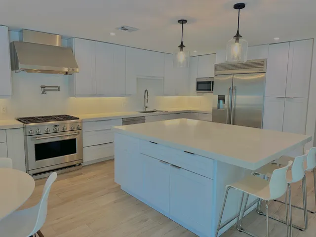 a kitchen with a stove a sink and a refrigerator