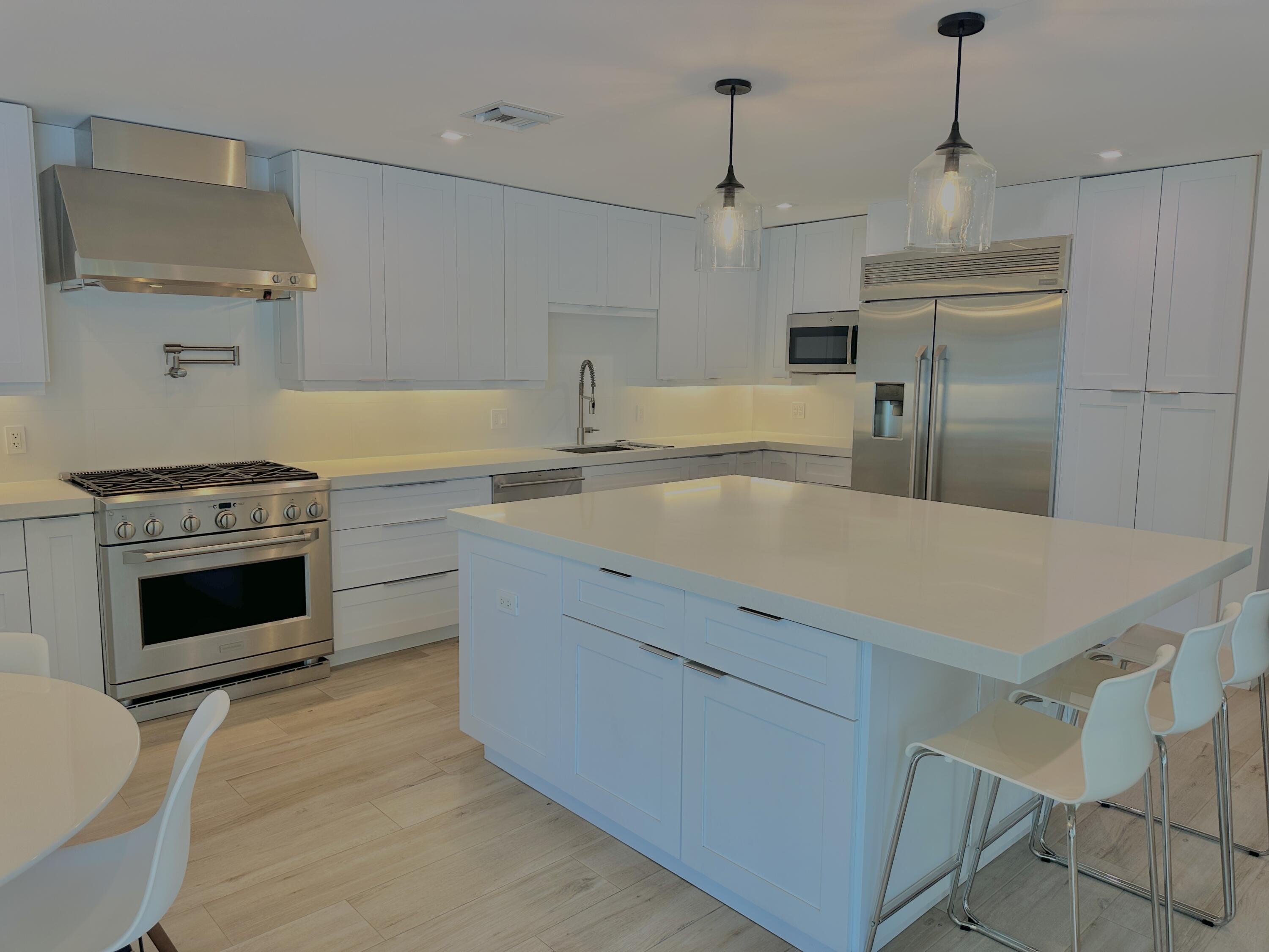 936 Southwest 38th Court Boynton Beach, FL 33435 - Photo 7 of 18 a kitchen with a stove a sink and a refrigerator