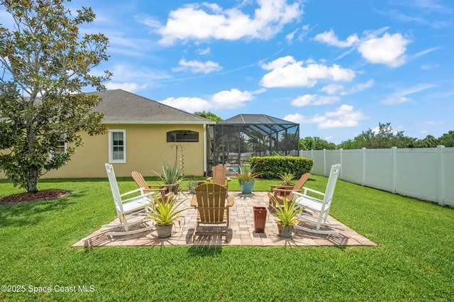 a view of a chair and table on the garden