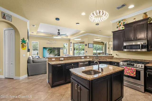 a kitchen with a stove sink and a refrigerator