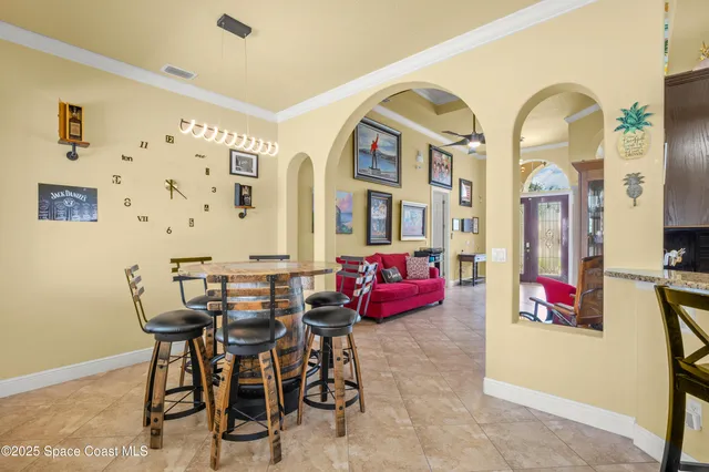 a view of a dining room with furniture and chandelier