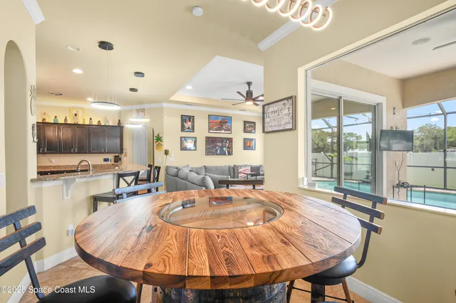 a dining room with furniture and a large window