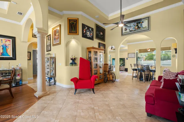 a living room with furniture a rug and white walls