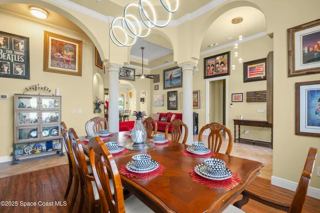 a view of a dining room with furniture and chandelier