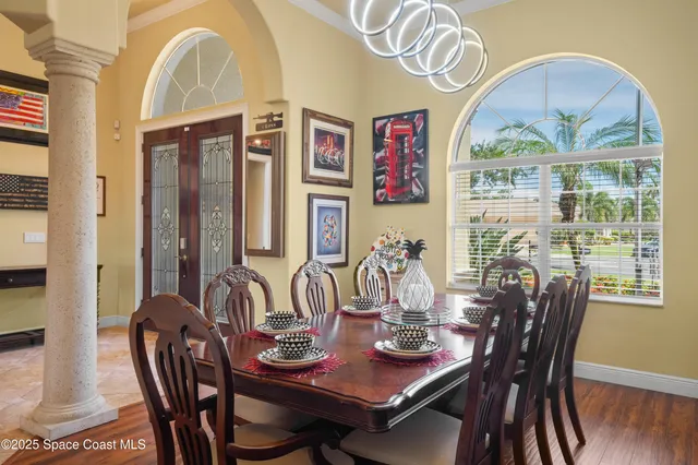 a view of a dining room with furniture large window and wooden floor