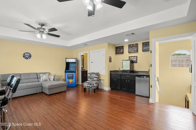 a living room with furniture and wooden floor