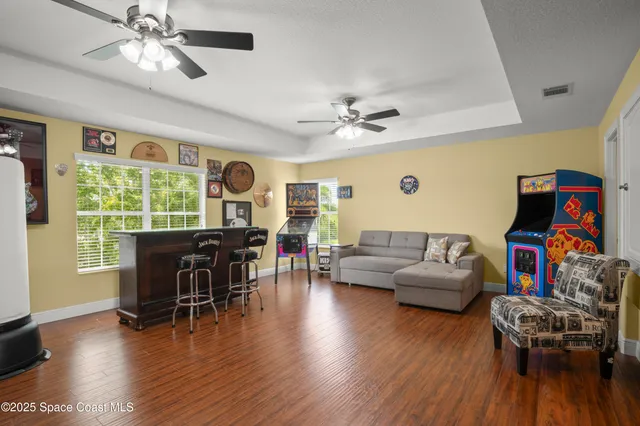 a living room with furniture and wooden floor