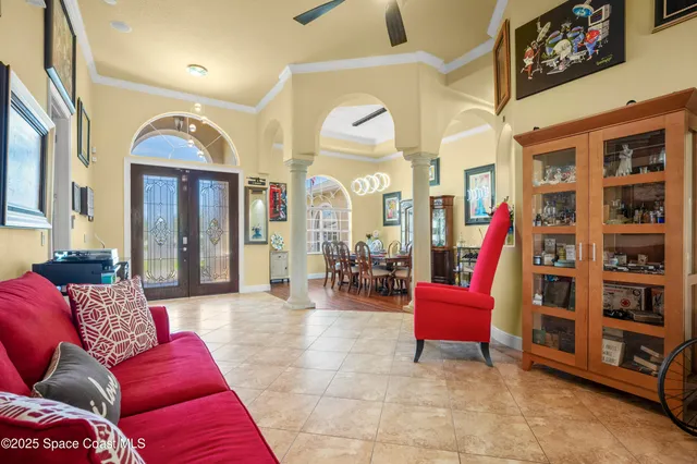 a living room with furniture and a book shelf