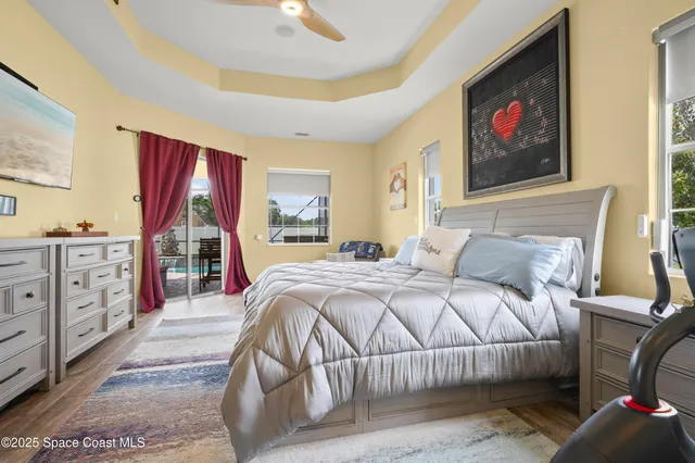 a bedroom with a large bed and a painting on the wall