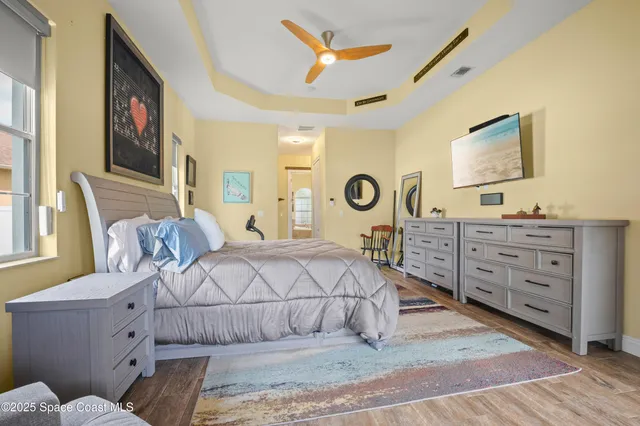 a bedroom with a bed and a chandelier