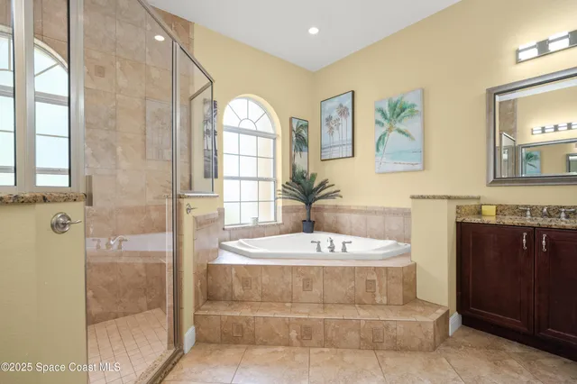a bathroom with a bathtub sink and a mirror