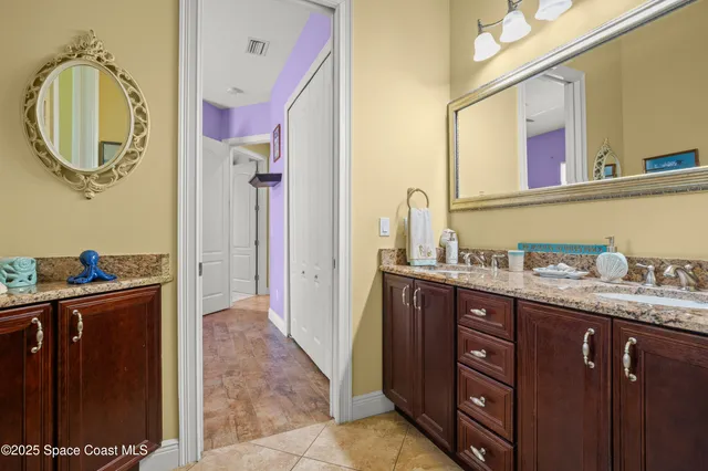 a bathroom with a granite countertop sink a mirror and a shower