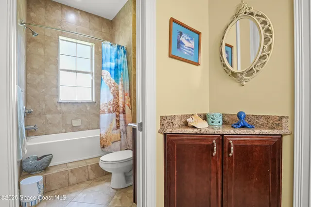 a bathroom with a granite countertop toilet a sink and a bathtub